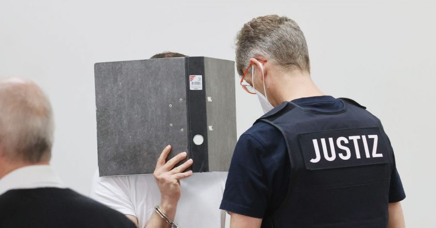 Der Angeklagte (M) wird in Handfesseln in den Verhandlungssaal des Landgerichts Gera geführt.
