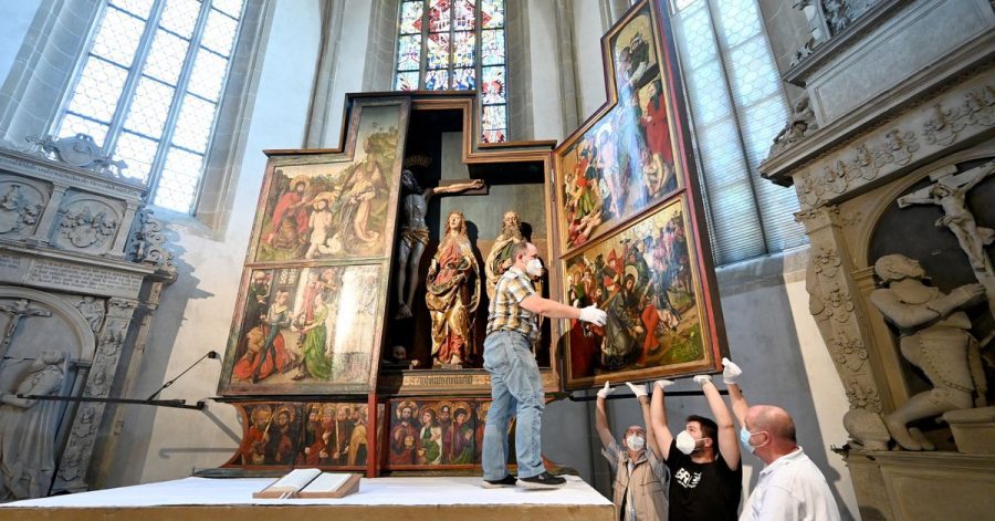 Um ein möglicherweise neu entdecktes Werk von Albrecht Dürer sichtbar zu machen, klappen Kirchenmitarbeiter der Johanneskirche ihren spätgotischen Flügelaltar zu.