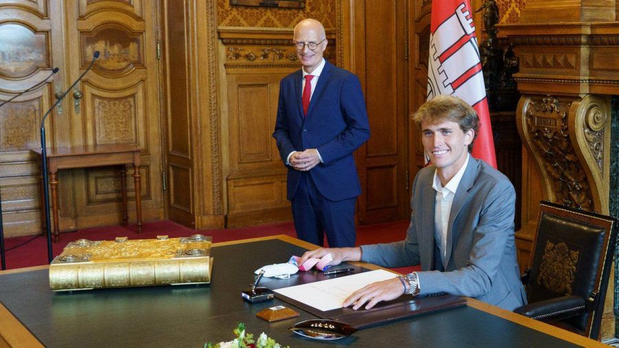 Alexander Zverev (vorne) trägt sich in das Goldene Buch der Stadt Hamburg ein (wue/spot)