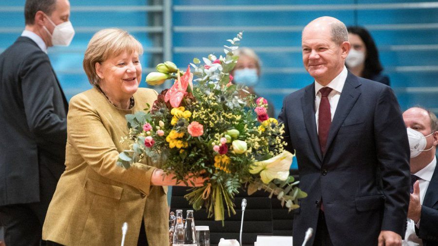 Angela Merkel freut sich über die Abschiedsblumen von Olaf Scholz. (eee/spot)