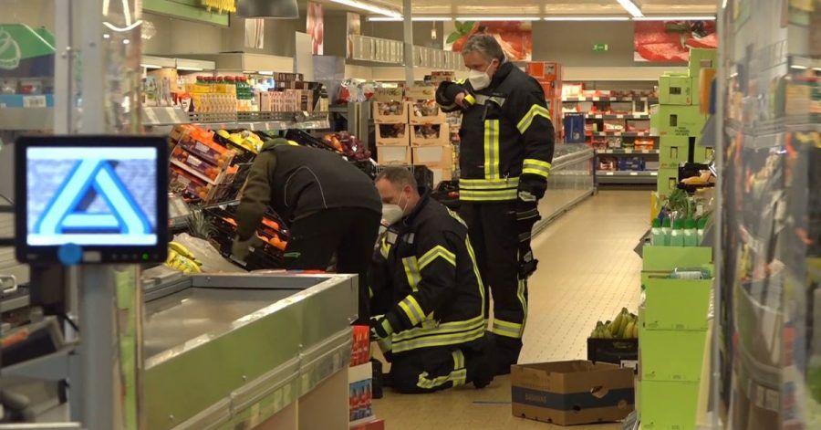 Einsatzkräfte der Polizei, Feuerwehr und ein Spinnenexperte suchen in den Obst- und Gemüseregalen des Supermarktes nach dem Tier.