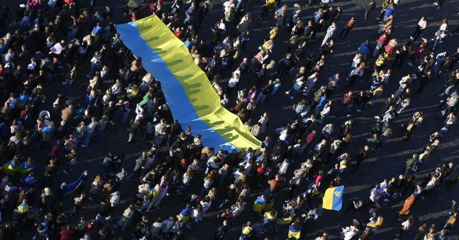 Menschen schauen auf dem Altstädter Ring in Prag die Übertragung des Streaming-Benefizkonzerts «Save Ukraine - #StopWar».