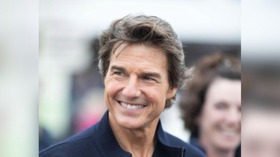 Tom Cruise strahlt auf dem Weg zur Queen. (smi/spot)