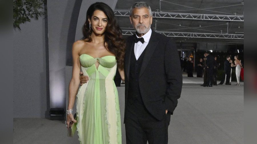 Amal Clooney in einem grünen Designerkleid und George Clooney im eleganten Dreiteiler. (mia/spot)